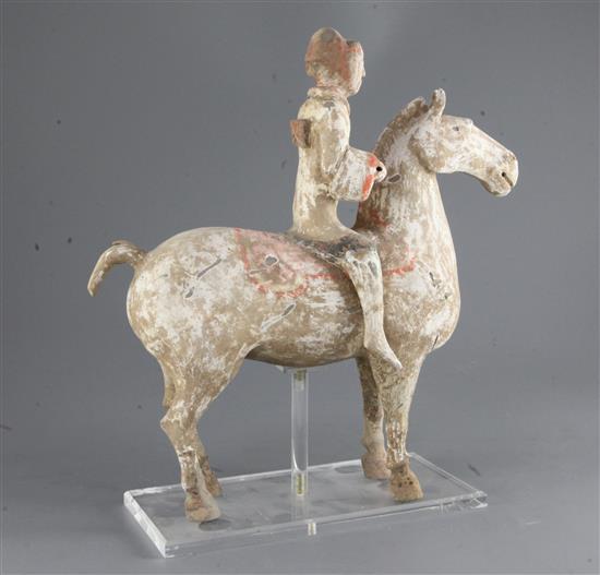 A Chinese pottery group of a horse and rider, Han dynasty, height 35cm, length 33.5cm